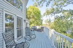 The deck spans the length of the house and has lots of outdoor furniture